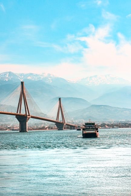 pexels photo 30527475 30527475 Majestic Rion-Antirion Bridge with ferry, set against Greek mountains and clear blue skies.